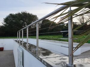 Stainless steel and glass balustrade frame on a rooftop under construction